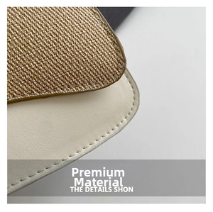 Detailed view of woven straw texture and premium cream leather stitching on the handbag
