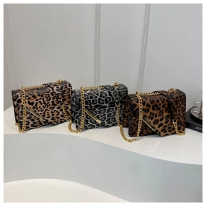 Three leopard print crossbody bags in brown and gray with gold chain straps