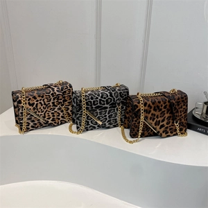 Three leopard print chain crossbody bags in classic, grey, and dark coffee on a white stand
