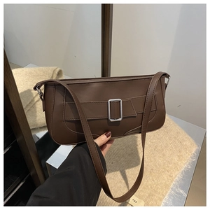 Detailed view of dark brown matte leather shoulder bag with vintage silver buckle strap