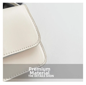 Close-up of beige leather bag showing premium texture and fine edge stitching detail