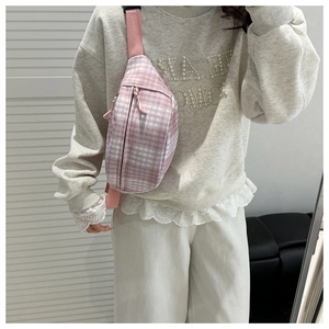 Detailed view of pink and white checkered crossbody bag with adjustable strap and zip