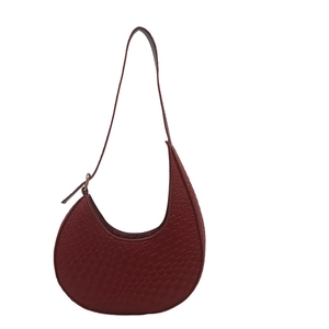 Chic burgundy woven leather crescent shoulder bag with adjustable strap for women