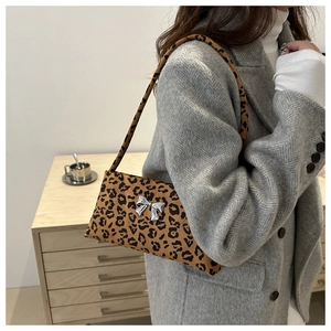 Leopard print baguette bag featuring a silver bow detail and slim shoulder strap