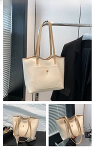 Detail of off-white tote bag with khaki straps and a large front pocket with snap button