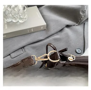 Close-up of leopard print handbag with golden metal clasp and premium zipper detail