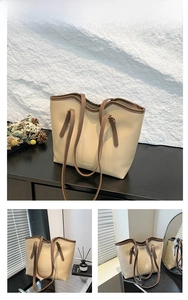 Close-up of khaki matte PU leather tote bag with elegant golden embossed lettering