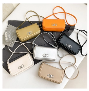 Detail of crossbody bag set with CD metal twist locks and textured synthetic leather