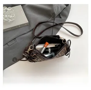 Internal view of leopard print baguette bag showing storage for phone and cosmetics