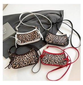 Close-up of leopard print baguette bags in white, black, dark brown, and red variants