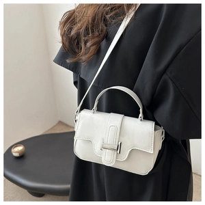 Detail of white minimalist crossbody bag with silver buckle and smooth leather texture