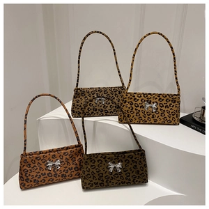 Detailed display of leopard print shoulder bags with silver butterfly metal buckles