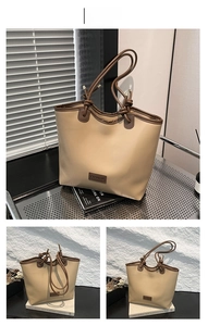 Detail of khaki tote bag featuring knotted handles and a rectangular fashion label