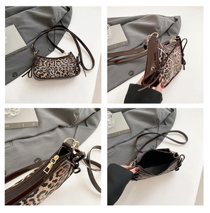 Detail view of leopard print crescent bag featuring side bows and gold-tone metal hardware