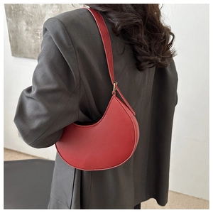 Chic red crescent underarm bag shown on model back for stylish daily commute outfits