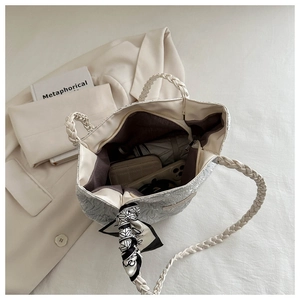Interior view showing large storage capacity of cream tote bag with scarf detail