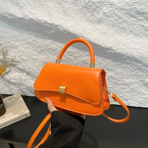 Minimalist orange leather hourglass handbag with golden buckle and adjustable shoulder strap