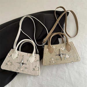 Floral embroidered woven mini tote bags in cream and tan with crossbody straps