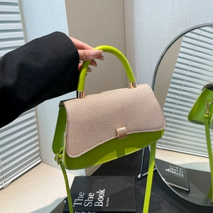Elegant lime green and beige woven crossbody bag featuring a golden buckle and top handle