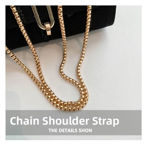 Detailed macro view of the premium golden box chain strap on the denim crossbody bag