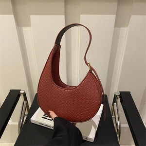 Modern reddish brown crescent shoulder bag with woven texture for a stylish urban look