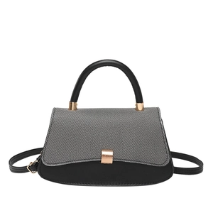 Minimalist bicolor trapezoid handbag with gray denim texture and golden metallic clasp