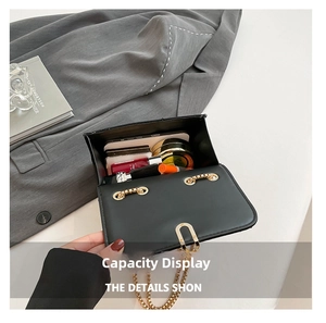 Detail view of the spacious black leather crossbody bag interior showing daily essentials