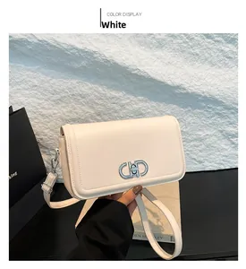 Detail of white faux leather bag with silver metal interlocking clasp and fine stitching