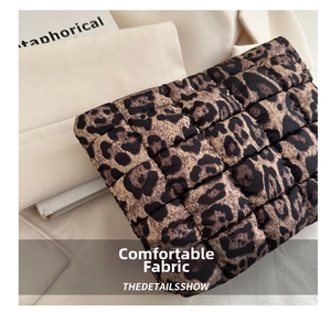 Detailed view of quilted leopard print clutch bag with soft texture and chic pattern