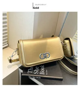 Close-up of golden leather shoulder bag featuring a unique silver metallic interlocking clasp