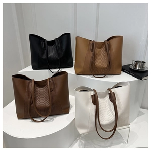 Four elegant crocodile texture tote bags in black, tan, brown, and cream displayed on steps