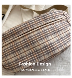 Detailed view of the vintage plaid waist bag with textured fabric and metallic zipper