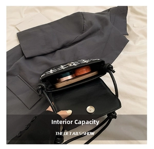 Detail view of the tweed crossbody bag interior showing space for phone and makeup