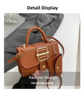 Detail of caramel lychee leather handbag with golden buckle and mini pouch attachment