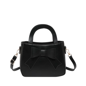 Chic black handbag with large 3D bow accent and adjustable shoulder strap for women