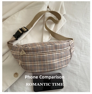Detail of vintage plaid chest bag with size comparison next to a black smartphone