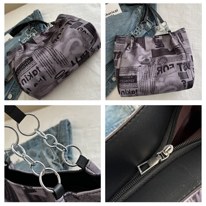 Detail of graffiti tote bag showing vintage newspaper print and metal chain strap details