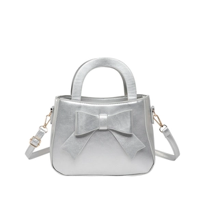 Silver bow shoulder bag with top handle and metallic finish for a stylish look