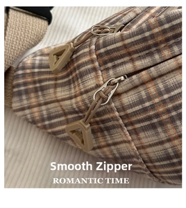 Detailed macro view of the premium plaid bag featuring a smooth double zipper and durable fabric