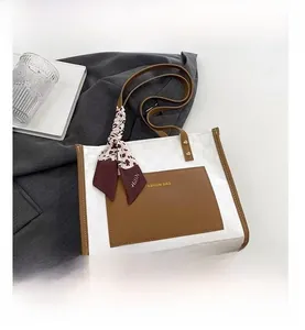 Detail of white tote bag with brown outer pocket and leopard print silk scarf decoration
