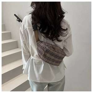 Rear view of a model wearing the vintage plaid crossbody bag with adjustable strap