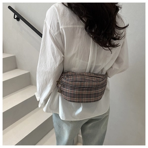 Classic red plaid waist bag with double-headed metal zippers shown on a model