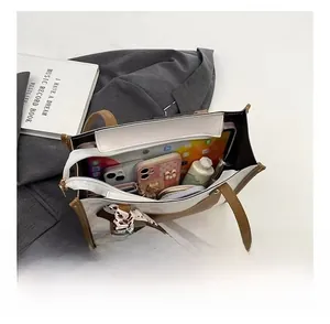 Top view showing large interior capacity of two-tone tote bag with tablet and accessories