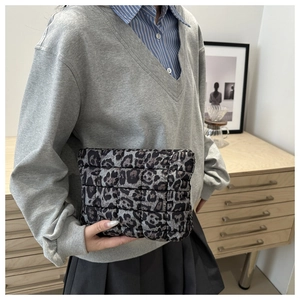 Macro detail of leopard print quilted clutch bag with soft padded texture and modern design
