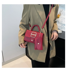 Detail view of red lychee pattern tote and small coin pouch combo on fashion model
