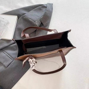 Internal view of large tote bag showing spacious capacity, zipper pocket and silk scarf decor