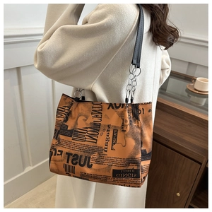 Dettaglio della borsa tote graffiti vintage con stampa di giornale e catena in metallo