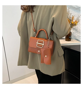 Caramel brown lychee textured leather crossbody bag with gold buckle and mini coin purse