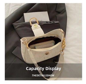 Interior view of white textured shoulder bag showing spacious storage for essentials