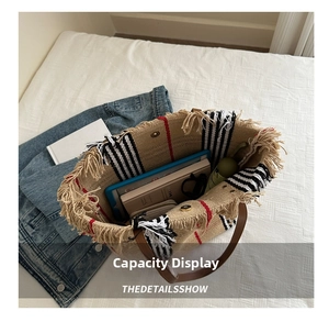Interior view of a woven striped tote bag showing large capacity for tablets and umbrellas